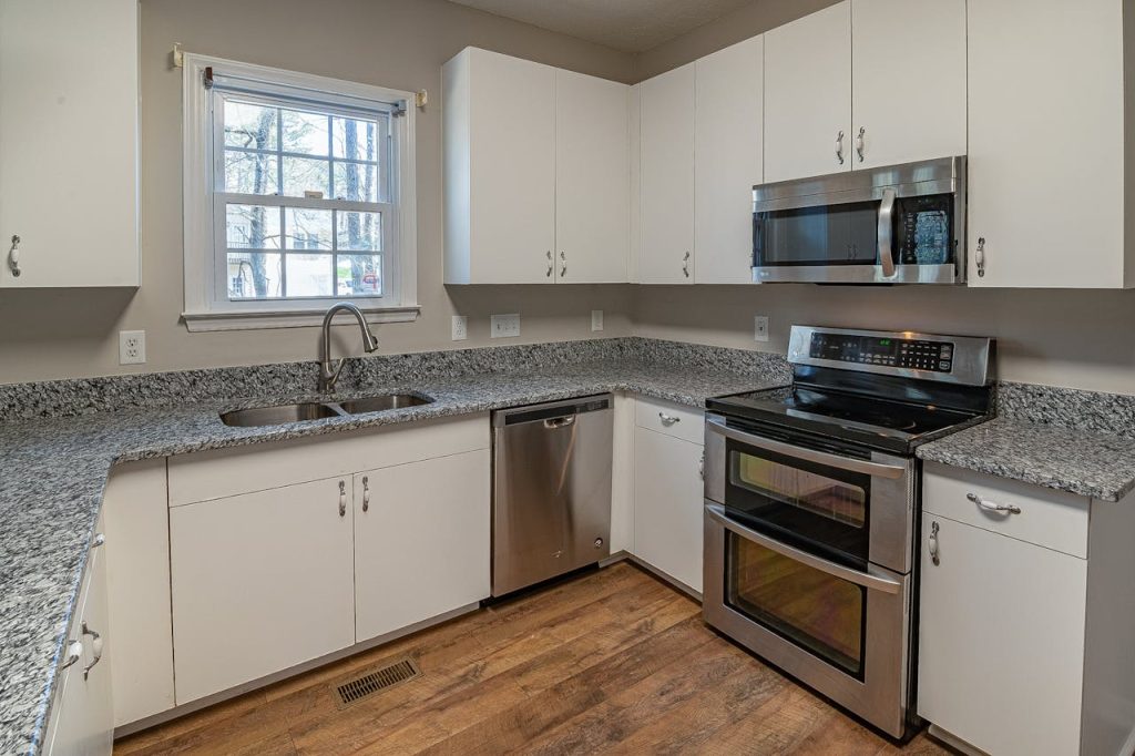 A sleek modern kitchen featuring stainless steel appliances and granite countertops.